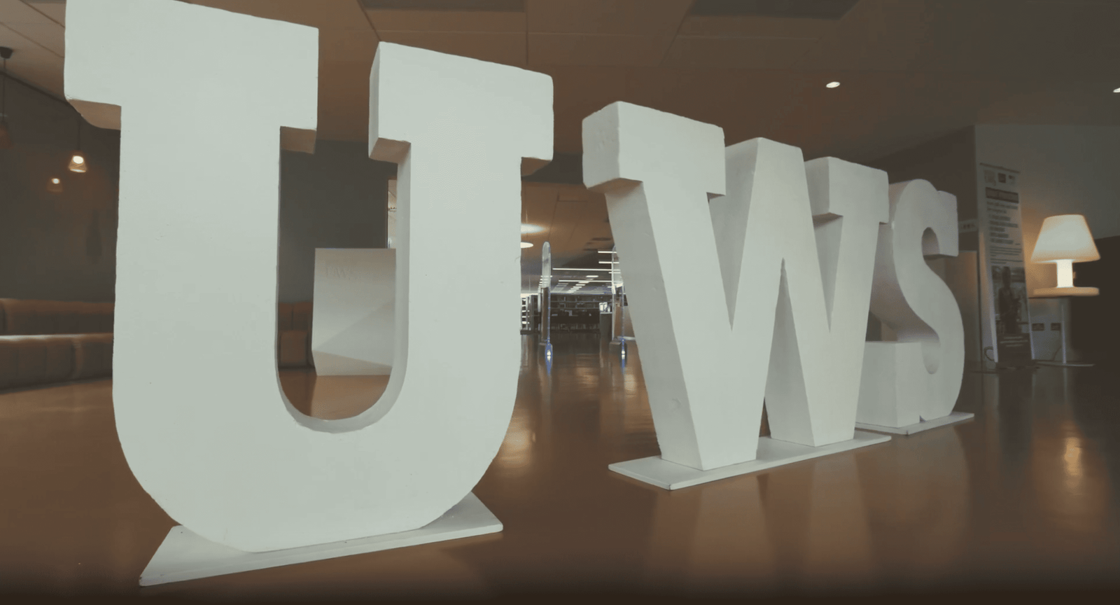 A large white sign with the word uws on it, representing the legacy and global recognition of the University of the West of Scotland.
