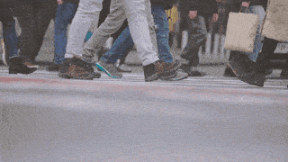 Aretian pedestrians cautiously crossing a street together.